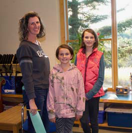 two girls and their mom in a classroom